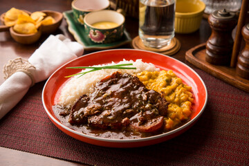 Fried cow liver with locro pumpkin stew Buffet table Peruvian comfort restaurant gourmet food