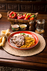 Fried cow liver with locro pumpkin stew Buffet table Peruvian comfort restaurant gourmet food