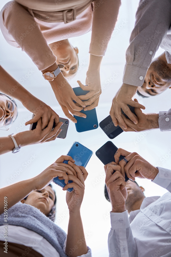 Fototapete Social media, smartphone and business people networking with a global community using technology together. Group and team typing, surfing and searching online on web communication app from below view