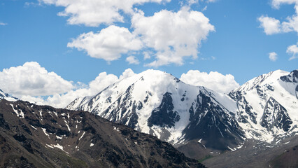 Fototapeta na wymiar snowy mountain peaks in the clouds. mountain gorge. glaciers on mountain tops