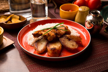 Fried chicken stew with baked potatoes Peruvian comfort restaurant gourmet food