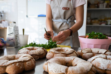 Finished French bread in the bakery on the table. Rustic bread, the crown of the Bordeaux kings. Front view.