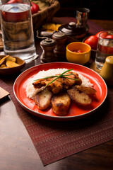 Fried chicken stew with baked potatoes Peruvian comfort restaurant gourmet food