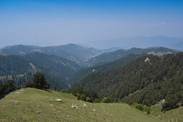 Fototapeta na wymiar Beautiful scenery of mountain valley, grassland and blue sky.