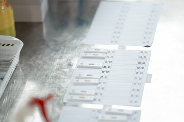 ATK results are place arranged on a paper number list on stainless silver table.