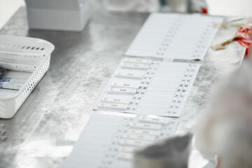 ATK results are place arranged on a paper number list on stainless silver table.