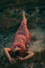 girls hands holding a wild flower on the background of the sea