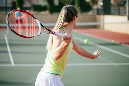 Motion shot of blonde athlete with long pony tail being active d