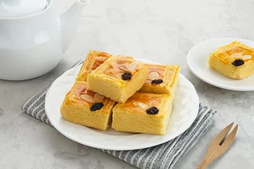 Foto op Plexiglas Lekker holland or dutch butter cake (boterkoek), made of butter, flour, eggs and sugar with a sprinkling of sliced ​​almonds and raisins  © Tyas Indayanti