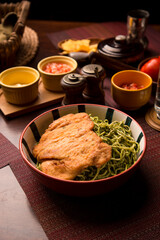 Green sauce pesto spaguetti noodles pasta with breaded chicken filet Peruvian comfort restaurant gourmet food