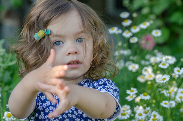 charming little girl shows something with gestures