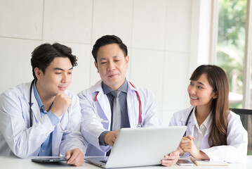 Group of Asian doctor meeting and discuss with other colleagues in modern office clinic room.