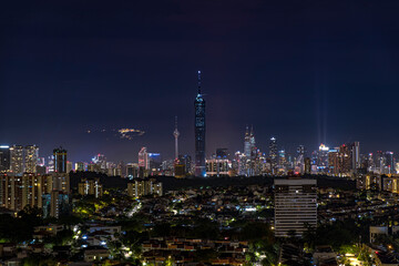 Fototapeta na wymiar Kuala Lumpur city skyline with Genting Highland behind the view.