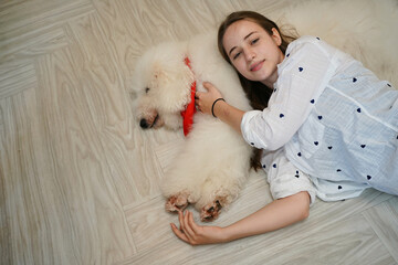 Young woman with her dog at modern house on nature light.