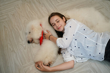 Young woman with her dog at modern house on nature light.