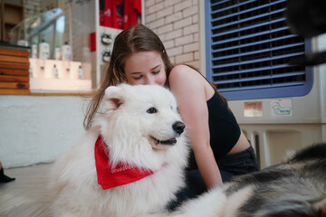 Young woman with her dog at modern house on nature light.