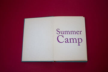 Summer Camp word in opened book with vintage, natural patterns old antique paper design.