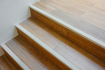 Modern wooden staircase with stair nosing strip. - obrazy, fototapety, plakaty