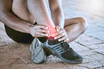 Runner with medical sports running injury and swollen ankle pain. Male athlete treating foot...