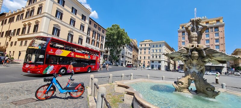 Scenic view with double decker red bus. Driving by red bus of city tour for tourists in historic centre of Rome. Beautiful Italian landscape on a sunny summer day. People like excursion. Great for edi