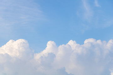 Fluffy clouds in blue sky - From below of fluffy white clouds floating over blue sky