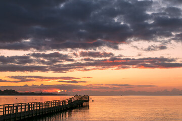 Silhouette of a pier at dawn.