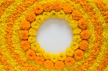 Decorative yellow and orange color marigold flowers and petals rangoli for Diwali festival with...
