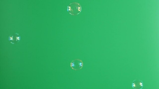Slow motion of soap air bubbles texture on chroma key green screen background
