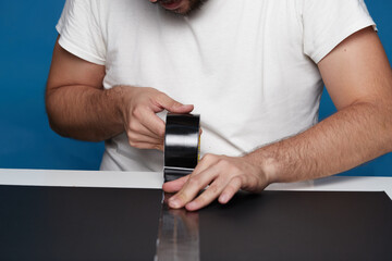 Anonymous person with zeal on a table with black cardboards