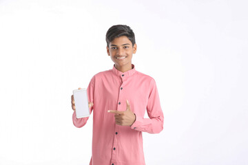 Indian college boy showing smartphone on white background.