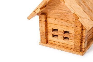 Obraz na płótnie Canvas Small wooden toy house. Background for the construction of housing from natural, environmentally friendly materials.