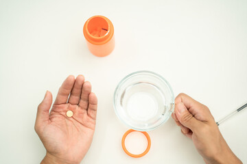 person putting pills  on their hands