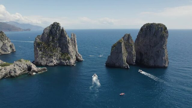Aerial View Of Boats Cruising In The Sea With Faraglioni Rock Formation In Capri, Italy.