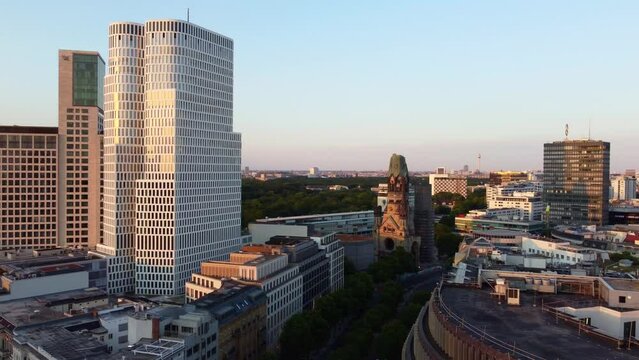 Around view west berlin Skyscrapers next to monuments.
Stunning aerial view flight pan to right drone footage of Kurfürstendamm at summer day sunset July 2022. P. Marnitz 4k Cinematic view from above