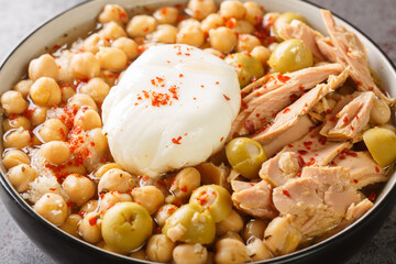 Lablabi is a popular Tunisian dish. It's a chickpeas soup served as a breakfast street food during cold days closeup in the bowl on the table. Horizontal