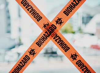 Biohazard caution, danger barrier tape of a quarantine zone. Bright orange safety stripes across...