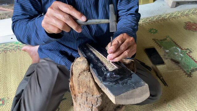 The process of making or carving a keris, a keris is a traditional Javanese sword, Indonesia.