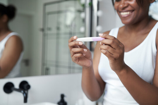 Close up of African-American stressed woman  waiting for pregnancy test results