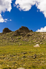 Landscape green mountain on blue sky background with white clouds, clean, windows xp style wallpaper