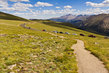 Landscape green mountain on blue sky background with cars driving on a road, white clouds, clean,...