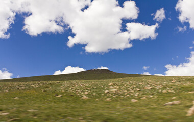 Landscape green mountain on blue sky background with white clouds, clean, windows xp style wallpaper