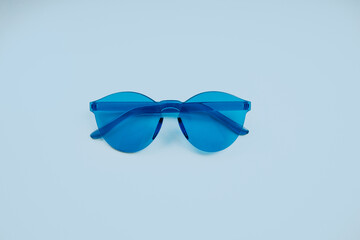 Blue glasses on a pastel blue background © Tanya Nef