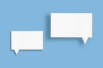 white paper with speech bubbles isolated on blue background communication bubbles