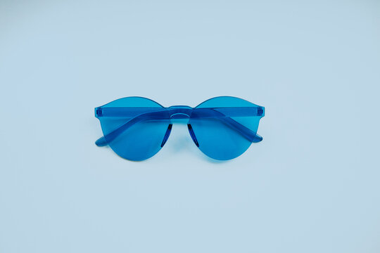 Blue glasses on a pastel blue background