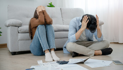 Asian couples managing debt and expenses. Husband and wife stressed over credit card bills and home electricity bills. Broke, mortgage, loan, bankruptcy, no money, bankruptcy, can't pay