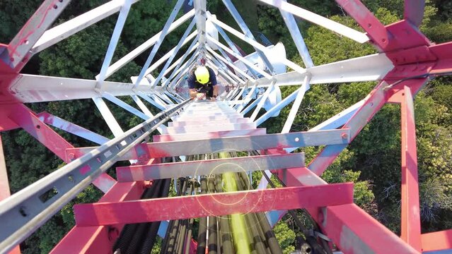 Engineer climbing to telecom tower to fix a broken cable, marked with graphics