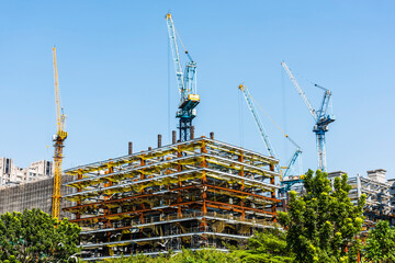 View of the building construction site with cranes in Kaohsiung, Taiwan.