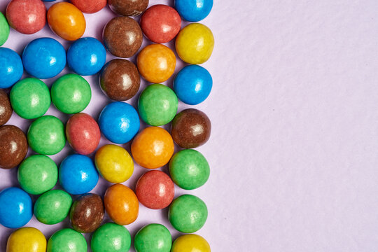 New MMs on a beige background. Background from a mms balloon. lots of sweets.