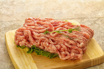 Raw minced pork meat over board