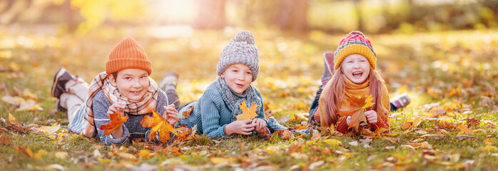 Group of children lying onthe ground in autumnal park